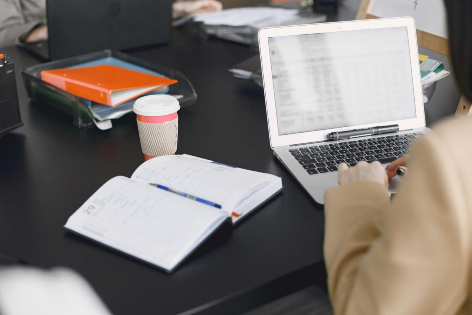 Student working on financial analysis project at desk